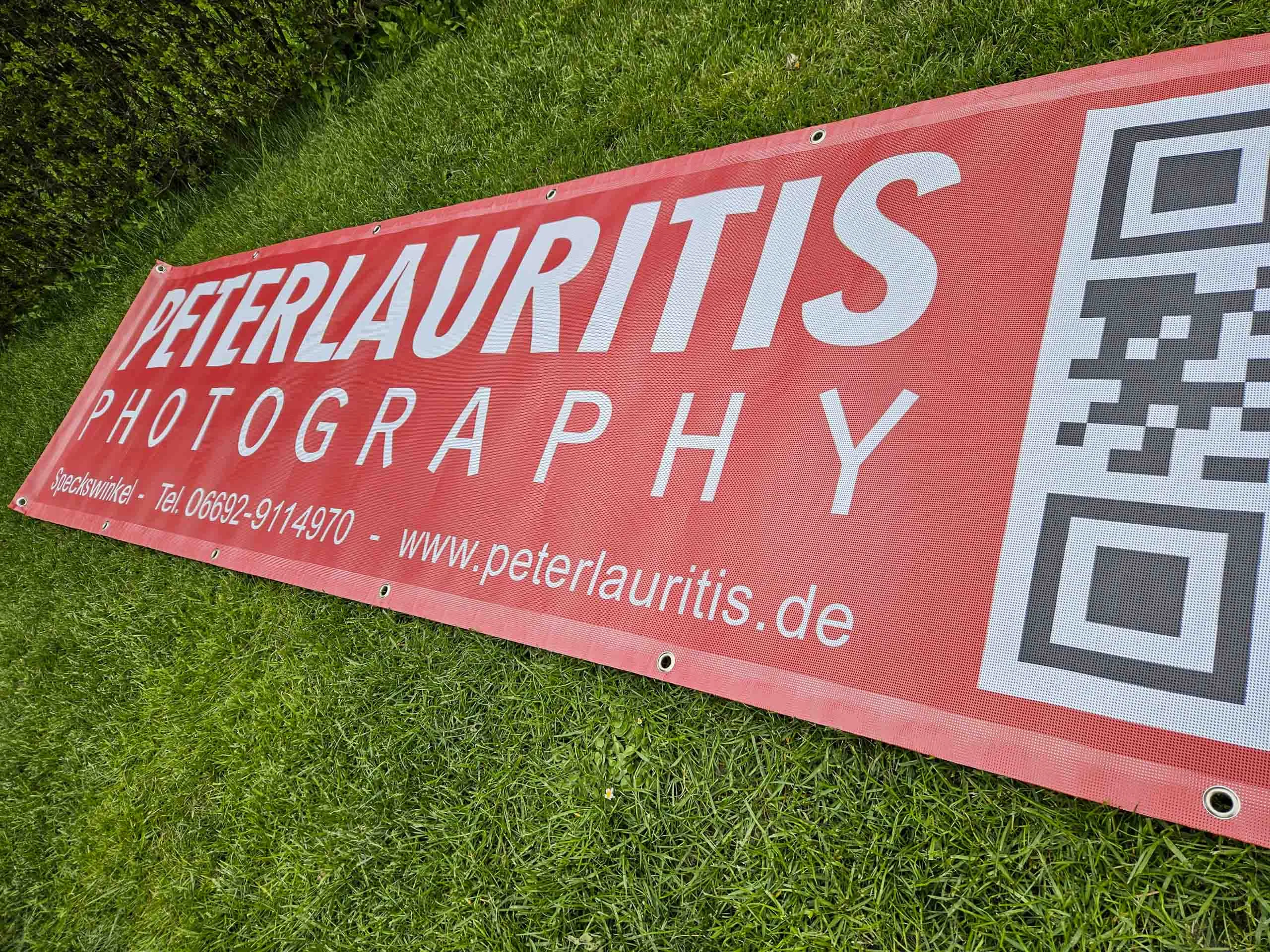 Einweihung des Waldstadions: rotes Werbebanner mit Logo, Telefonnummer und QR-Code