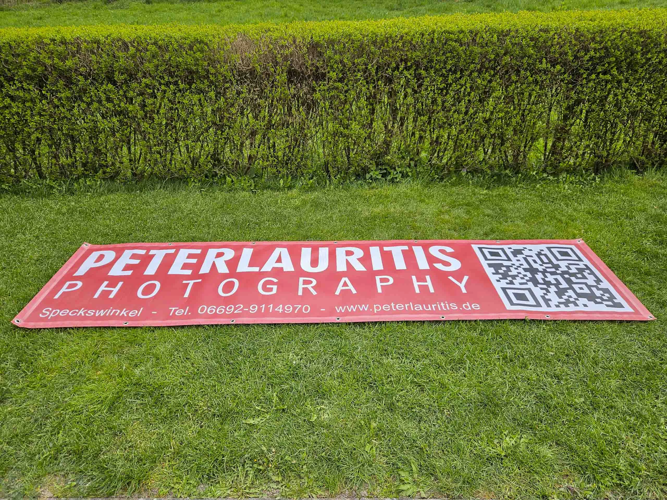 Banner zur Einweihung des Waldstadions: rotes Banner mit QR-Code ausgebreitet auf dem Rasen
