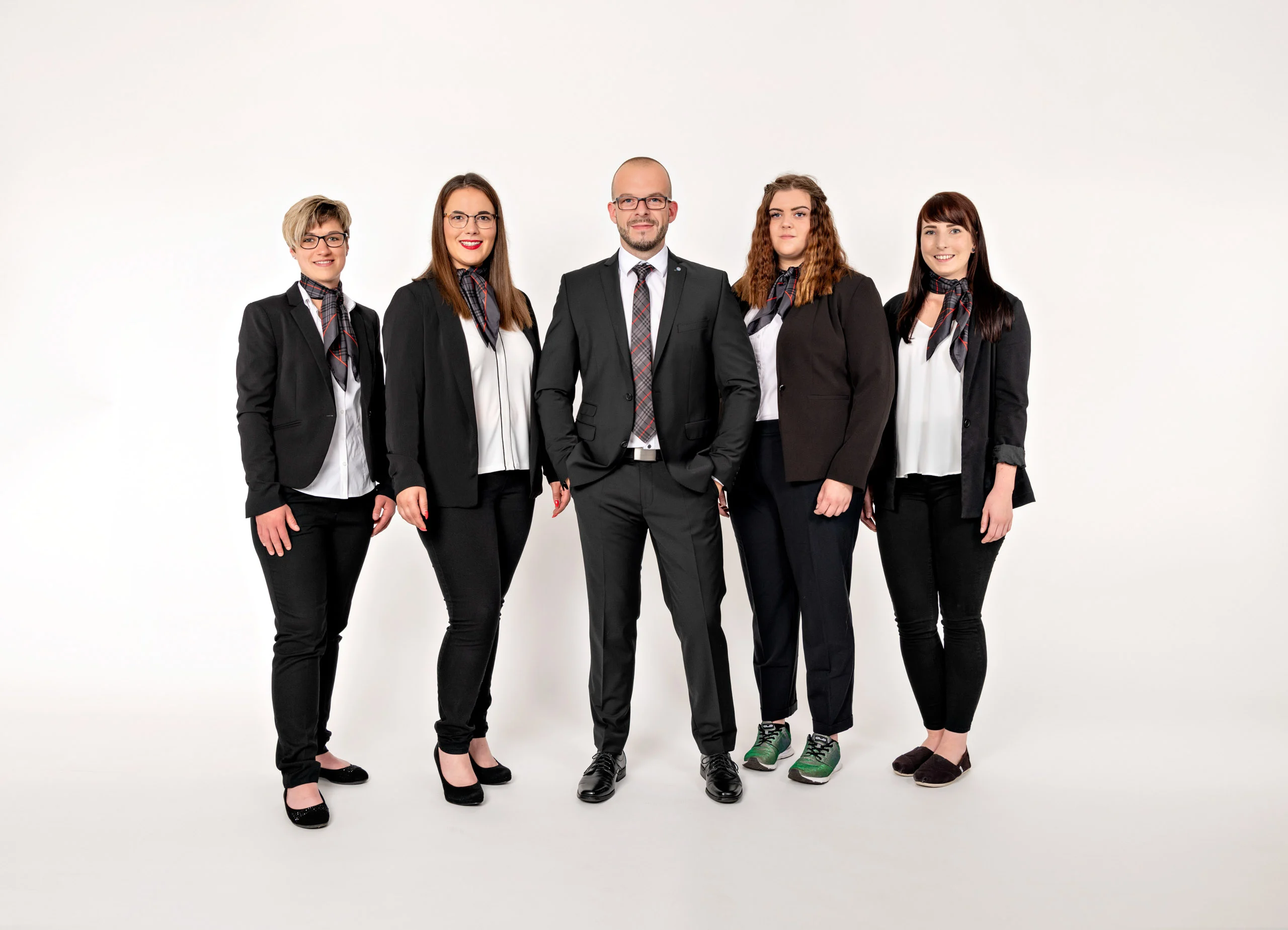 Business Portraits Fotogalerie 044 | Peter Lauritis Photography Team aus fünf Personen in schwarzer Businesskleidung steht nebeneinander